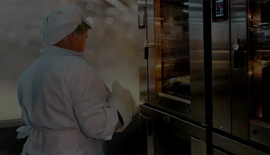 Baker testing commercial bakery ovens inside the Erika Baking Equipment test-kitchen at the Baker’s Lab.